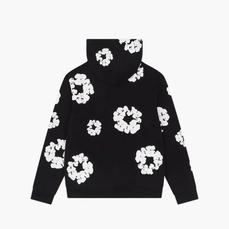 The Black “Cotton Wreath” Denim Tears Hoodie features a white floral ring print, blending bold streetwear design with comfort.