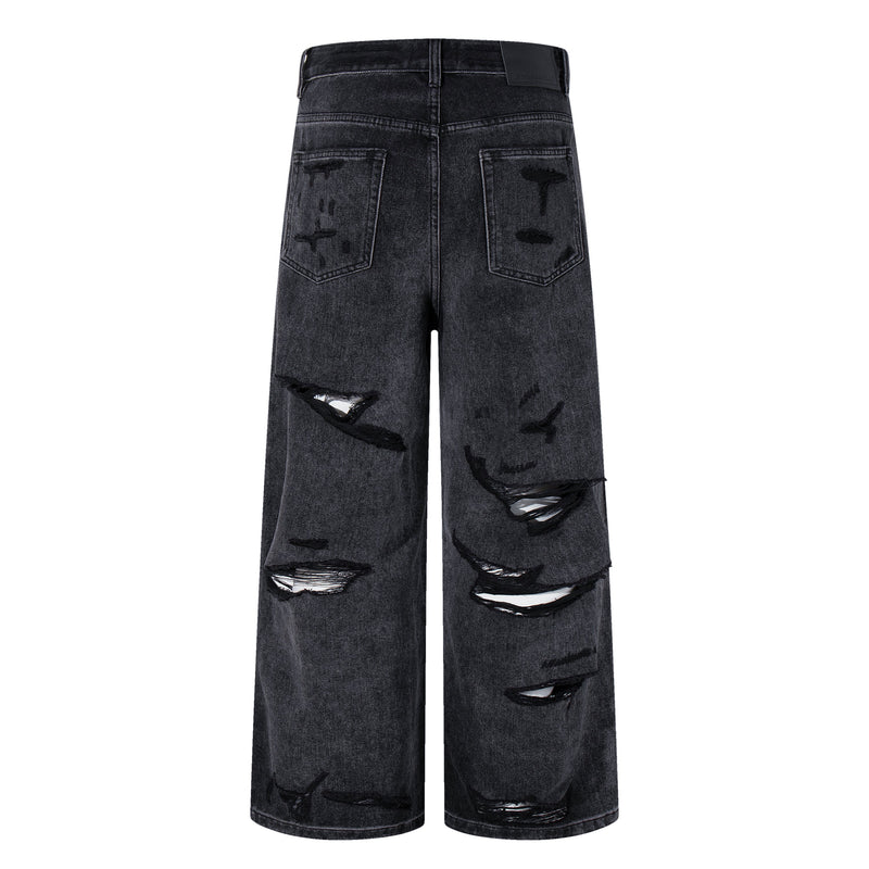 Back view of deep charcoal wide-leg jeans with distressed back pockets and coated finish