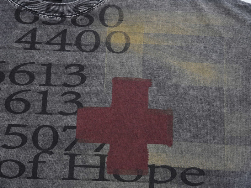 Vintage wash oversized graphic tee with faded numbers, red cross, and Rays of Hope print on gray fabric