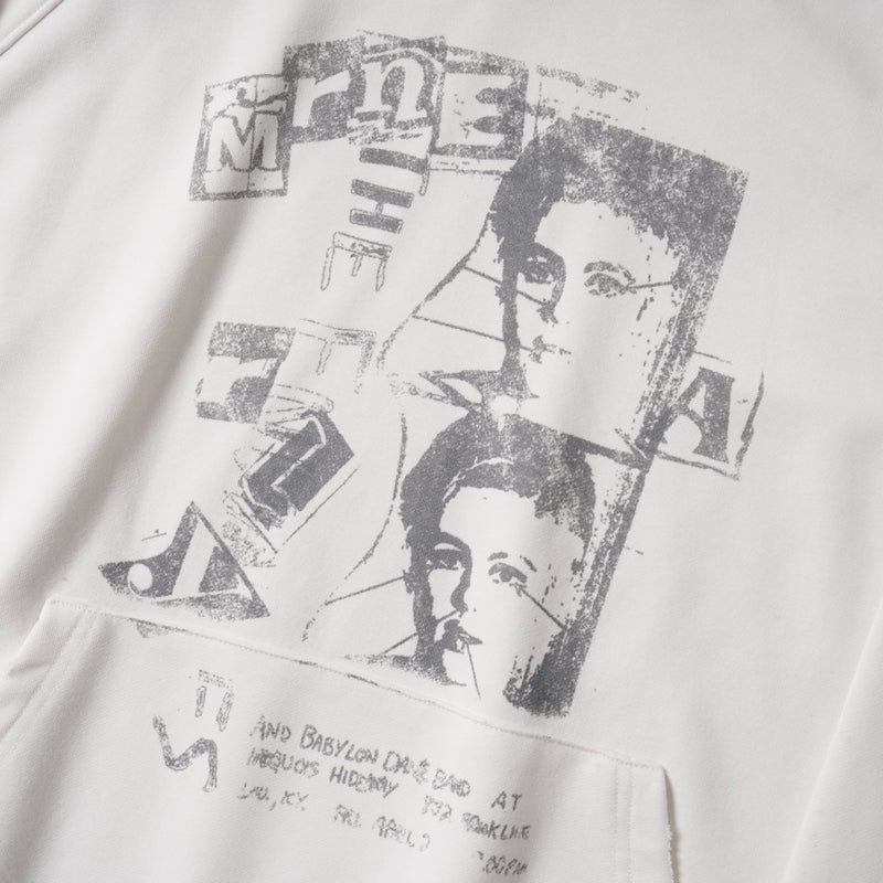 Close-up of front graphic on white hoodie with grayscale portrait collage and text