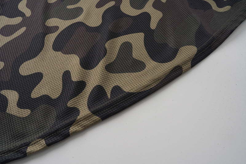 Close-up of camo jersey hem with black, tan, and olive pattern
