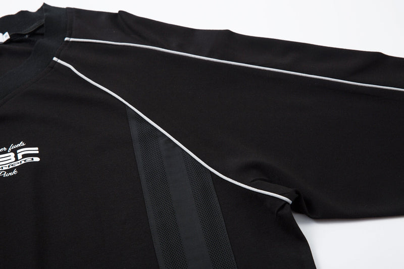 Black sleeve and shoulder panel detail with white piping and mesh insert