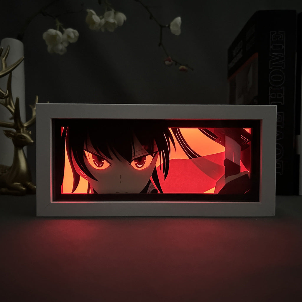 The Akame ga Kill! Anime Light Box features a rectangular 3D LED lamp with color-changing effects, depicting a character from Akame ga Kill with dark hair and large eyes set against intense red lighting. An Akame design resembling antlers adds intrigue amid some blurred objects.