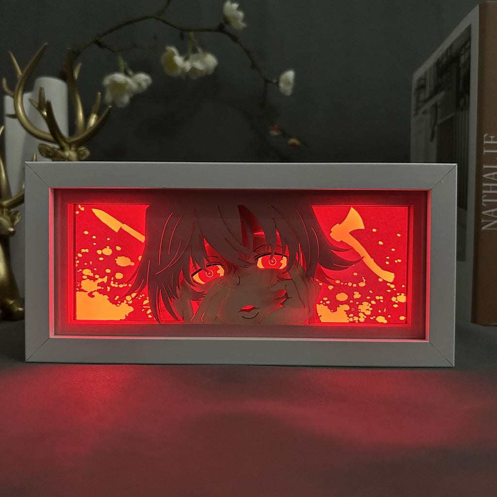 The Chainsaw Man Power Anime Light Box is a rectangular 3D LED lamp featuring intense eyes on a stylized face against a red background with axe-like patterns, complete with decor branches for depth and 16 color options controlled by remote.