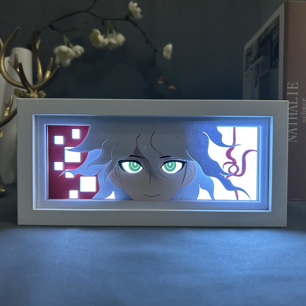 The Seakoff Danganronpa Nagito Komaeda Anime Light Box is a 3D LED lamp featuring an anime character surrounded by abstract red and white shapes. It casts a gentle glow with 16 colors, controlled via remote.