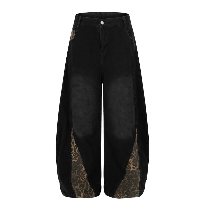 Back view of black wide-leg denim jeans with leopard-print side panels at the hem