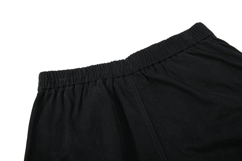 Close-up of black shorts elastic waistband and upper back seam