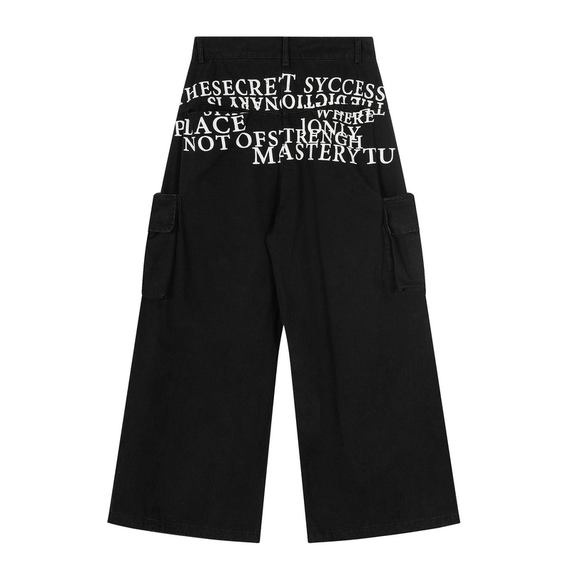 Back view of black cargo wide-leg pants with large white typography print across the seat
