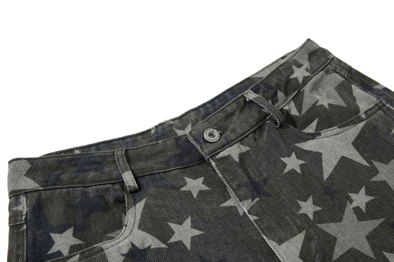 Close-up of the waistband on star print denim jeans with button and belt loops