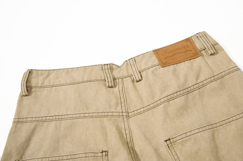 Close-up of khaki back waistband with tan leather patch and belt loops