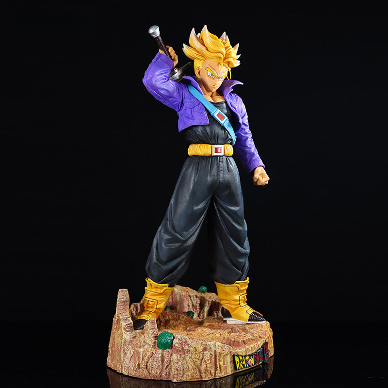 The Seakoff Trunks Collectible Figure from Dragon Ball Z is a 50cm figure featuring the hero in a sword pose, with interchangeable heads. It stands on a rocky base with green details and showcases Trunks in his Super Saiyan form with spiky blonde hair, purple jacket, black pants, and yellow boots.