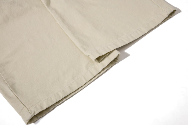 Close-up of beige cargo pant wide leg hem