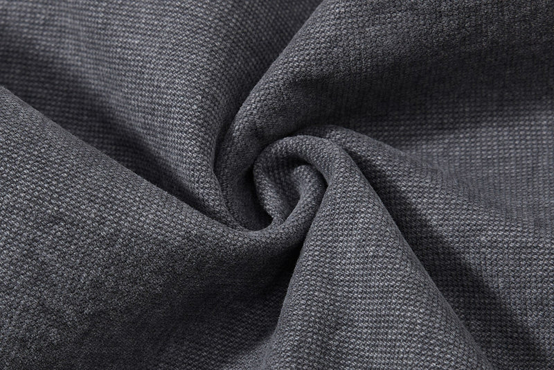 Close-up of charcoal denim fabric gathered in folds