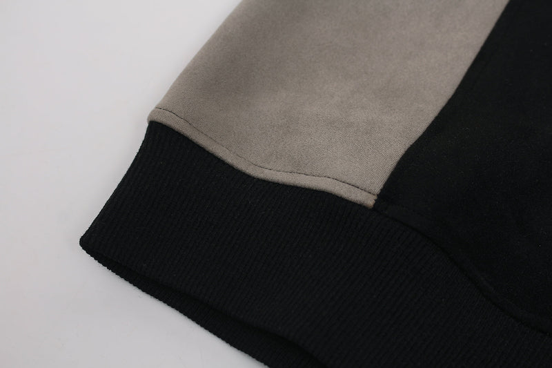 Close-up of beige sleeve hem and black ribbed cuff on hoodie
