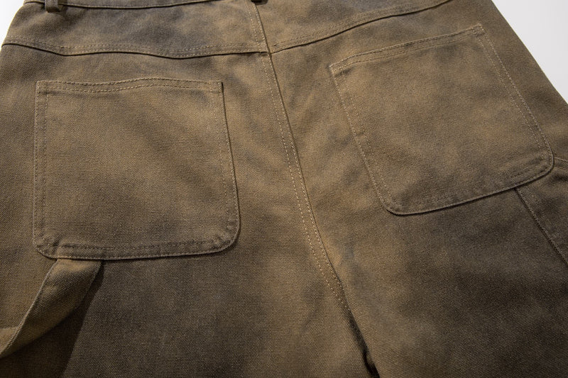 Close-up of back pockets on olive brown cargo shorts with faded wash
