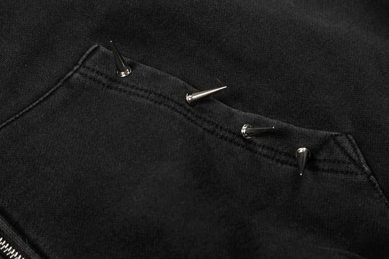 Close-up of hoodie pocket studs on black fabric