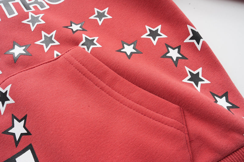 Red hoodie pocket area with star print and stitched front seam