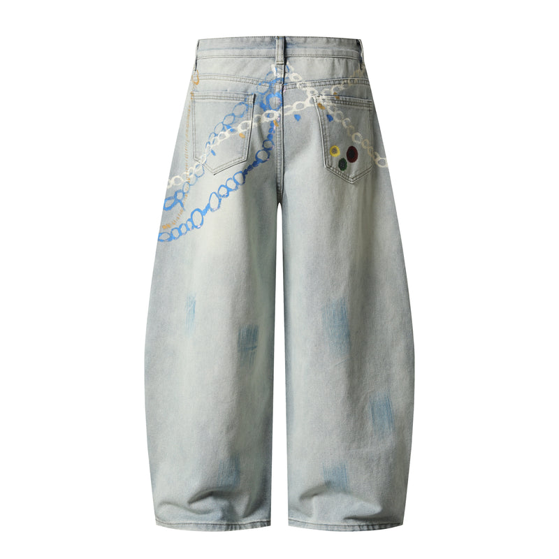 Back view of light wash wide-leg denim pants with painted chain design on the pockets