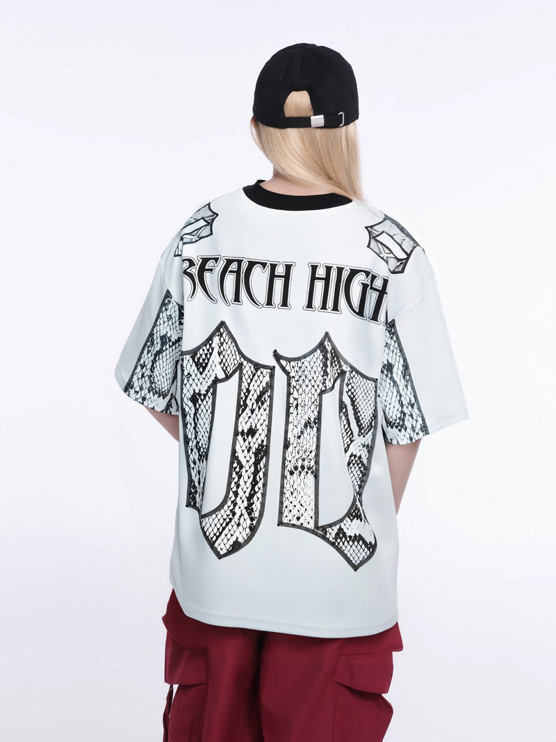 White oversized gothic jersey tee with black snakeskin graphics and Reach High logo on the back, streetwear style