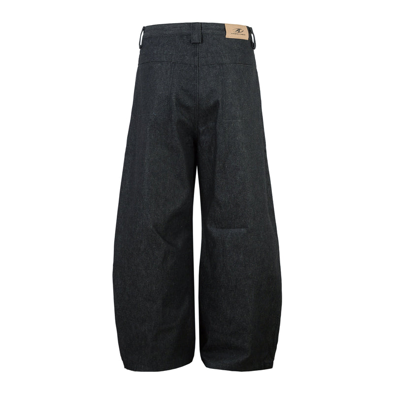 Back view of dark denim wide-leg pants with a tan logo patch at the waistband