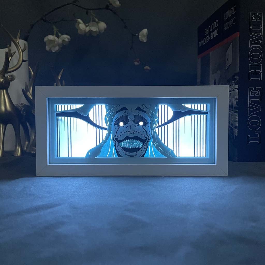 The Solo Leveling Anime LED Light Box by Solo Leveling displays a glowing, cartoonish skeletal face with an open mouth and large eye sockets. A plant and decorative reindeer against the dark background add mysterious vibes similar to the Monarch of Shadows, while &quot;LOVE HOME&quot; is partially visible on the right.