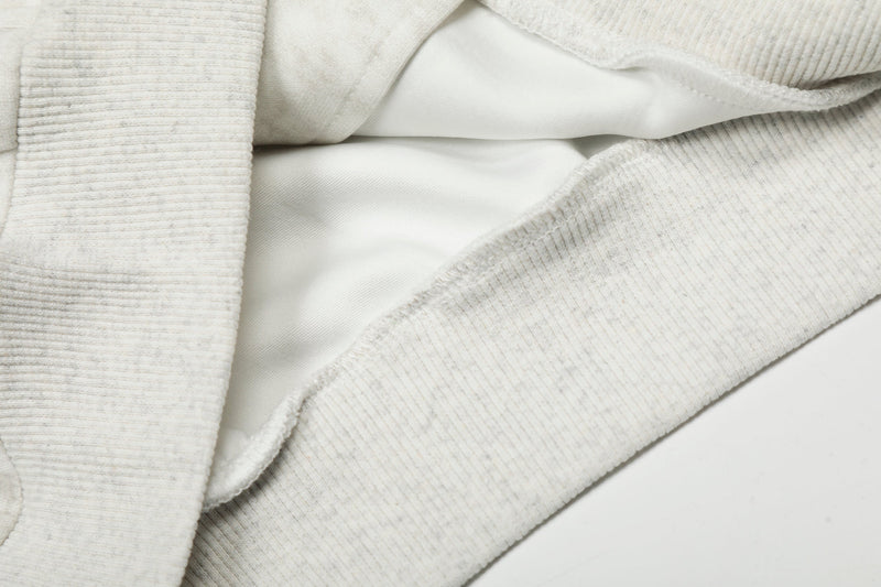 Close-up of interior lining and ribbed hem on white hoodie