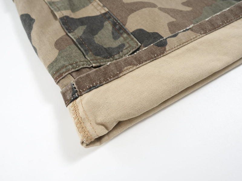 Rolled hem of beige-lined camouflage shorts with stitched seam and cuff edge