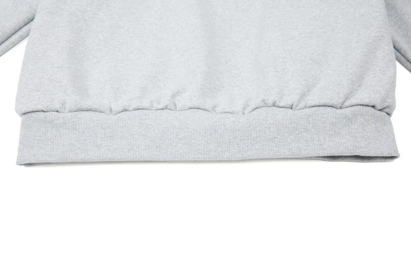 Close-up of light gray hoodie ribbed hem and gathered waistband
