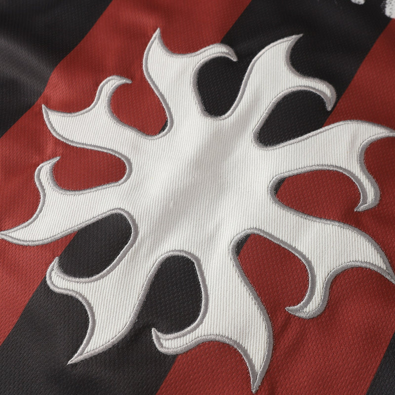Close-up of a retro soccer jersey tee with red and black vertical stripes and a bold white number 30 graphic