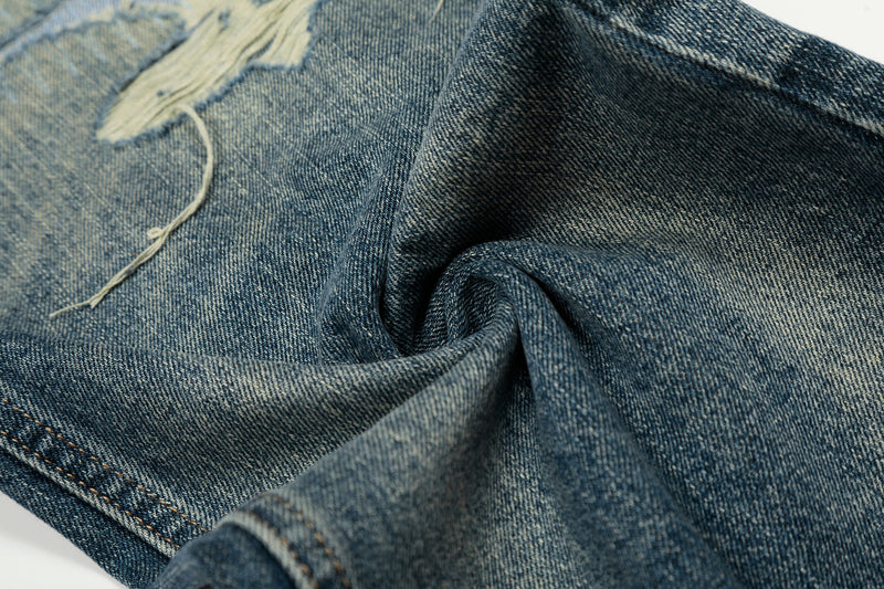 Close-up of soft faded denim texture with distressed detail