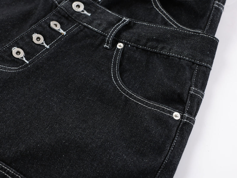 Close-up of the front fly and utility pocket on black denim pants
