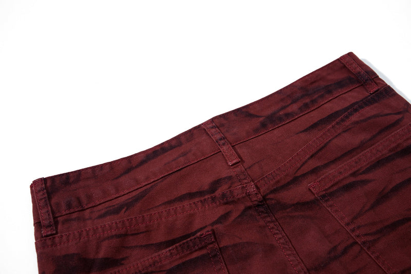 Close-up of the back waistband and pocket area on burgundy tiger-print pants