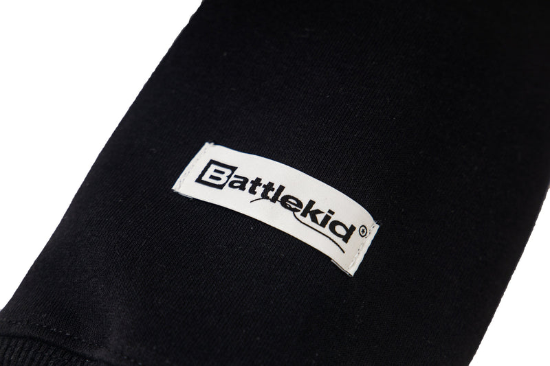 Close-up of black sleeve cuff with small Battlekid logo tag
