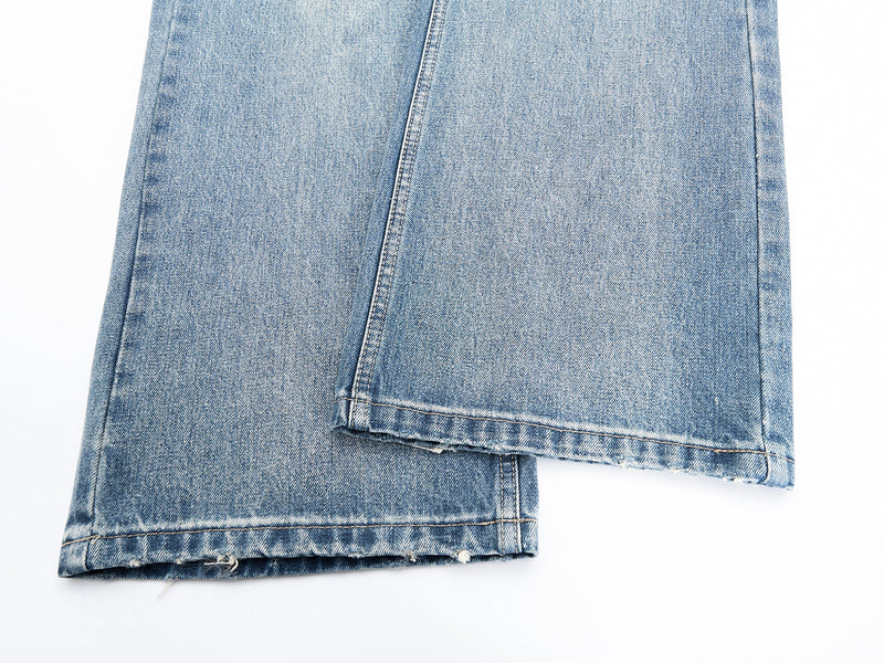 Close-up of hemmed pant legs on faded wide-leg denim jeans