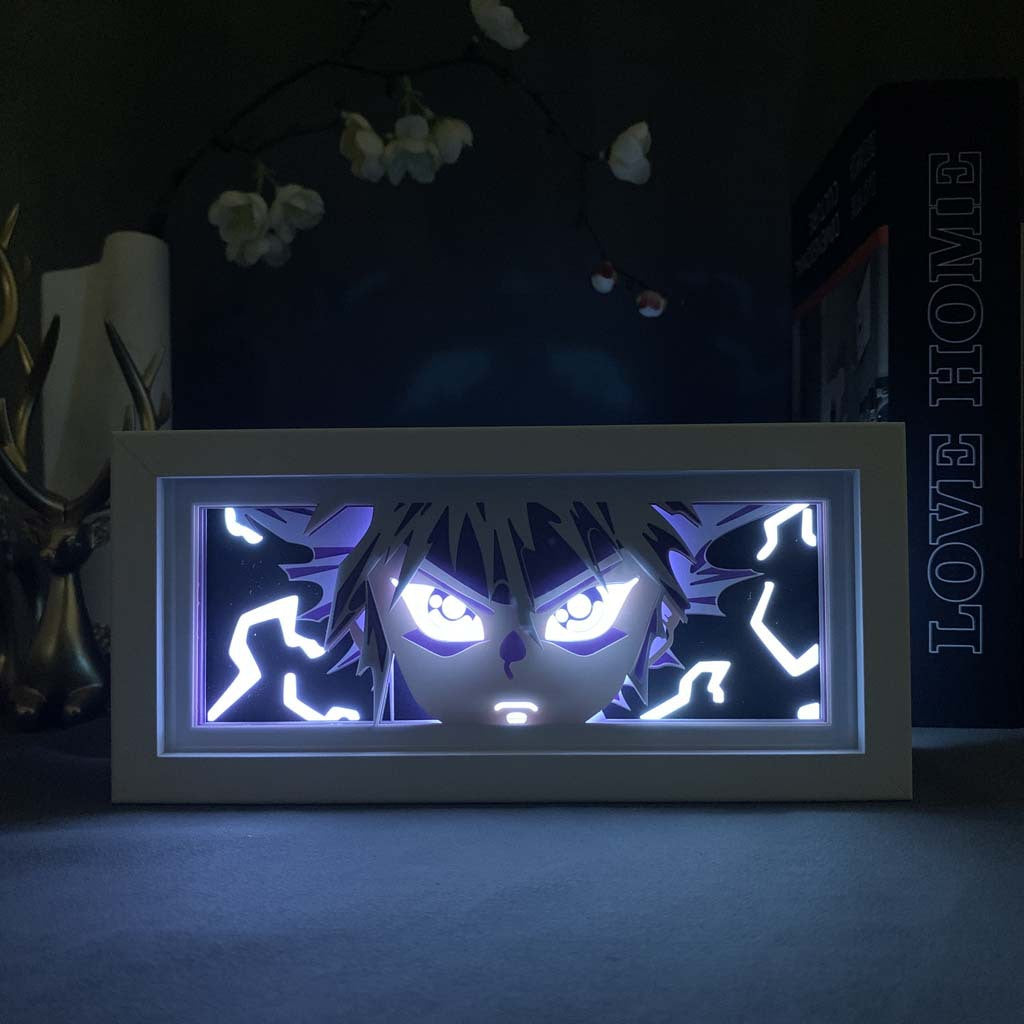 The Hunter x Hunter Killua LED 3D Light Box – Thunder Mode displays an anime character with intense eyes and spiky hair, surrounded by electric-like lines. It sits in a white frame near antlers and a &quot;Love Home&quot; box.