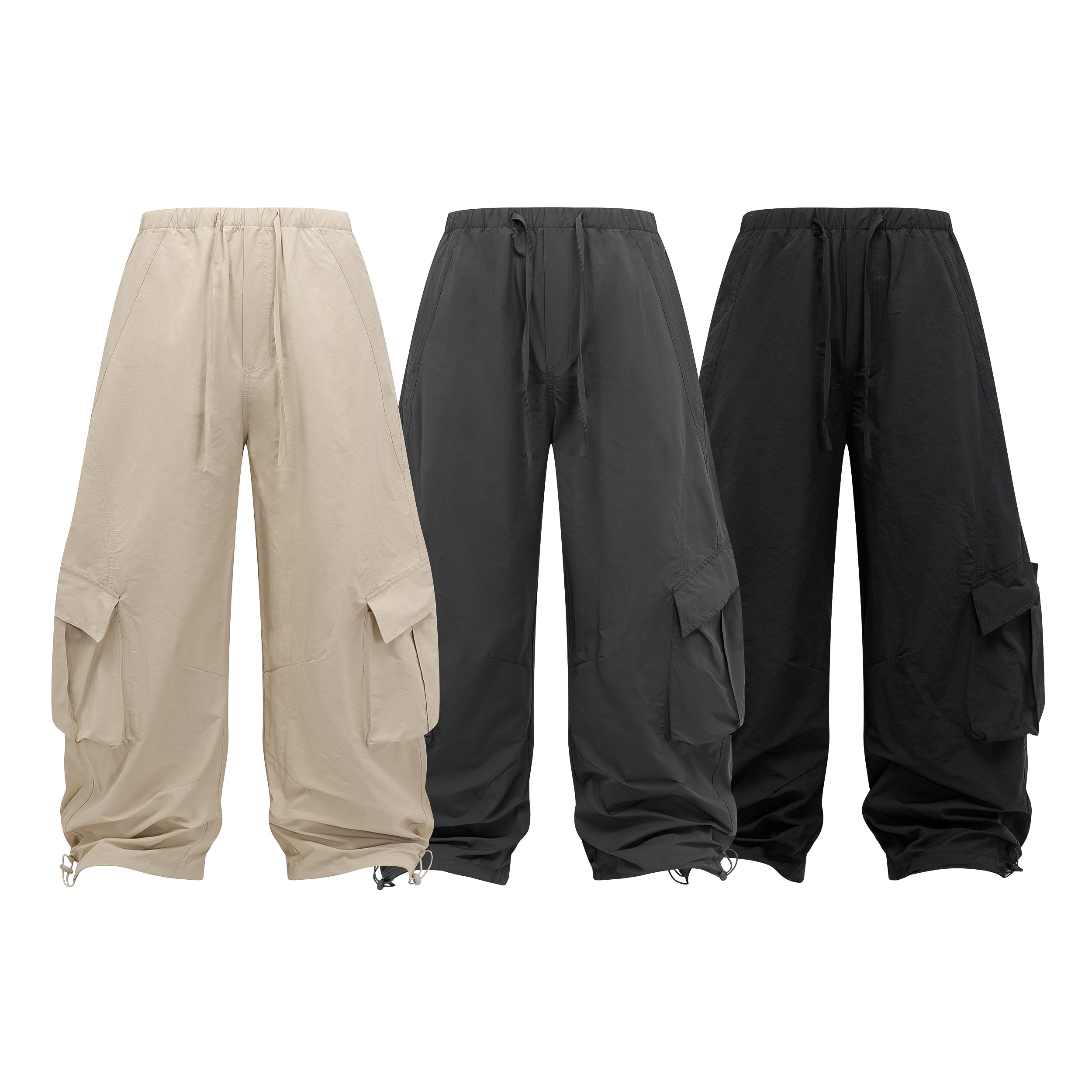 Beige wide-leg utility cargo pants with oversized 3D pockets, drawstring waist, and toggle hem, shown flat on white backgroun