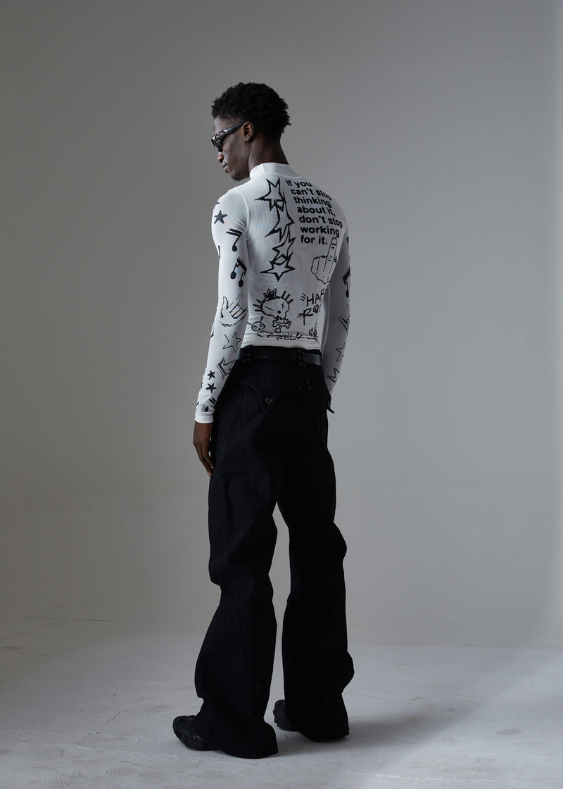 Back three-quarter view of white graphic long-sleeve top and black wide-leg jeans