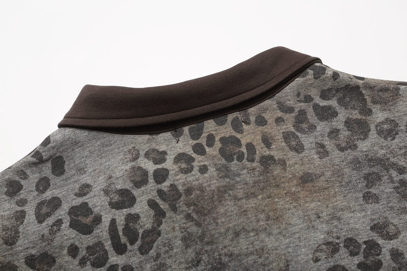 Close-up of a leopard print oversized polo tee with a dark brown collar and gothic streetwear style