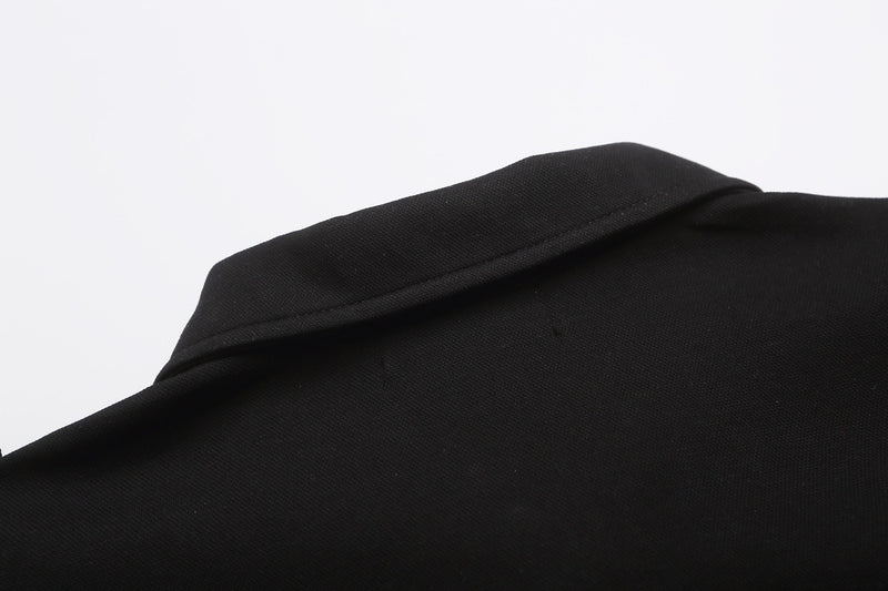Black military style polo shirt with structured shoulder epaulettes and textured fabric detail