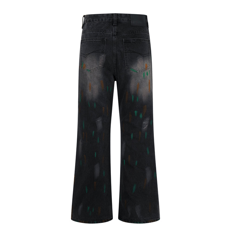 Back view of washed black wide-leg jeans with fading, painted marks, and patch pockets