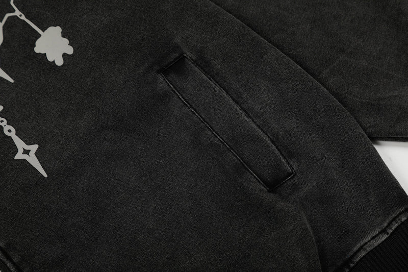 Close-up of black hoodie side pocket and chain print on the front panel