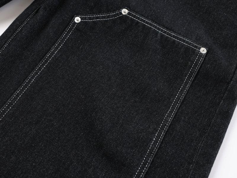 Close-up of large utility pocket stitching on black denim pants