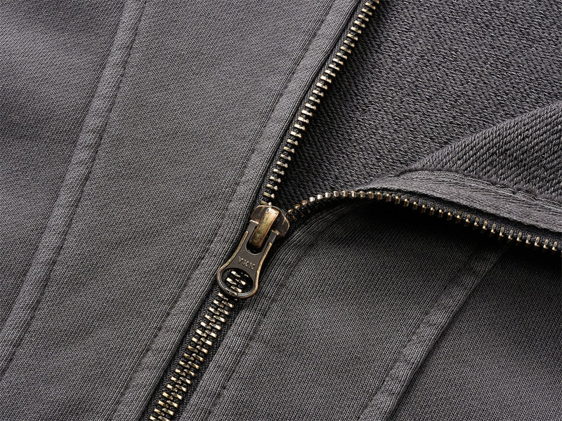 Close-up of black hoodie zipper with brass pull and fleece lining