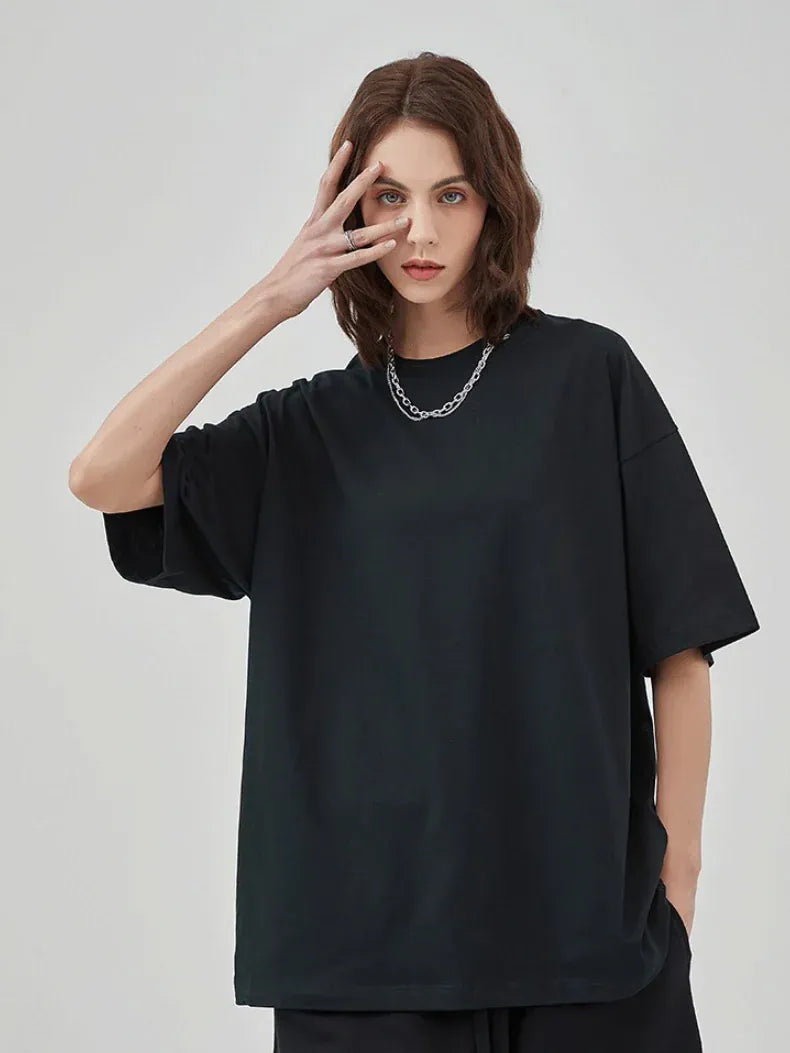 Wearing a Custom Anime Character Black T-Shirt—Personalized 230GSM 100% Cotton Tee—and a chain necklace, this person poses with one hand partly covering their face against a plain light background.