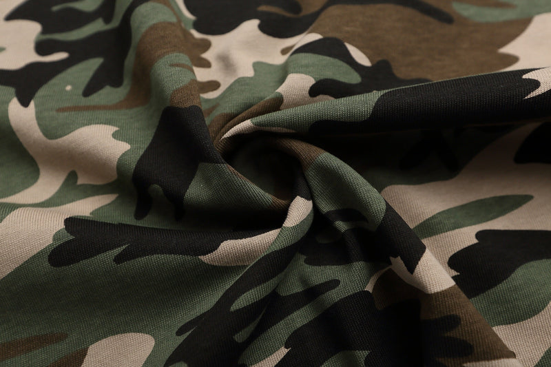 Close-up of camo knit fabric in green, brown, beige and black, showcasing the Seakoff Heritage Polo material texture