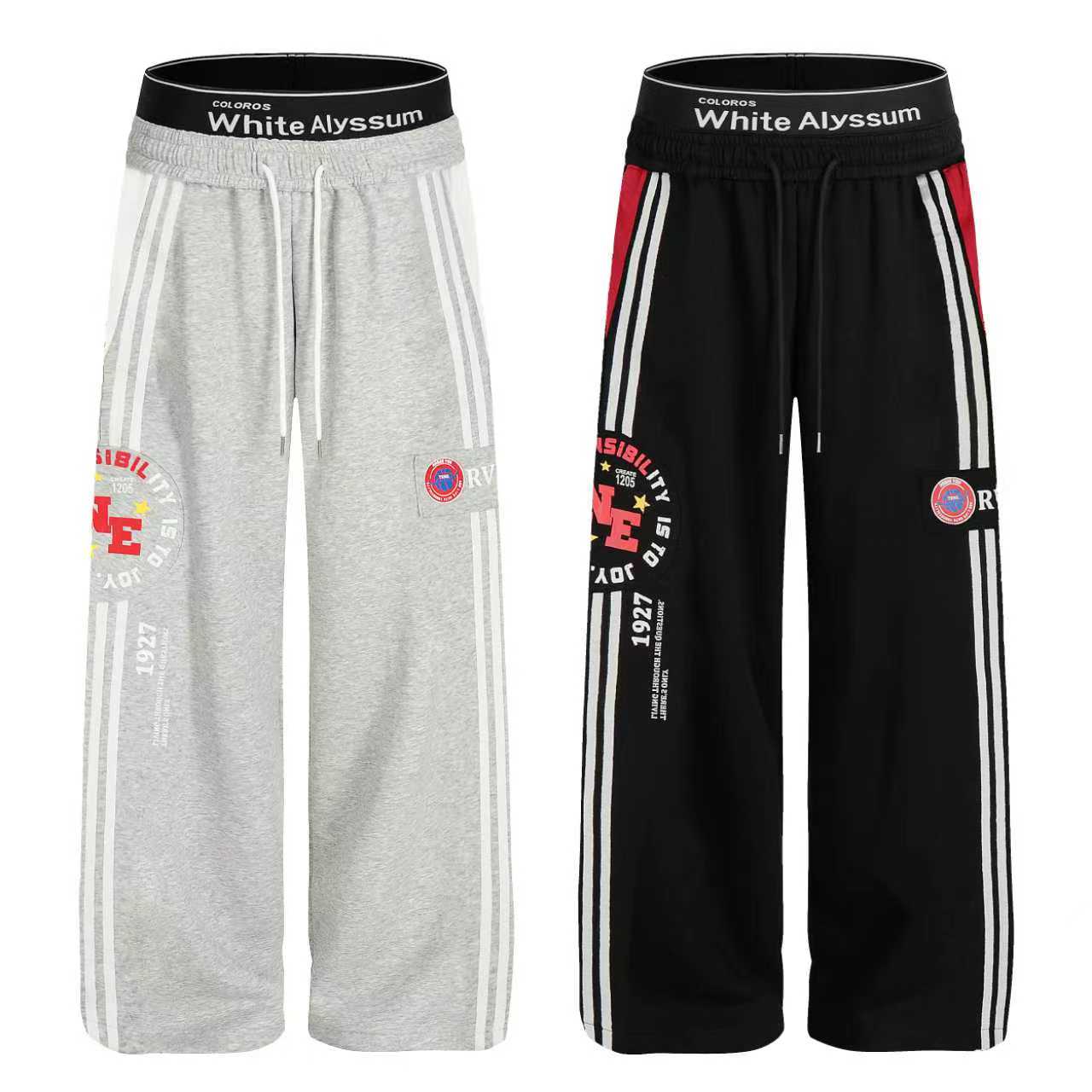 Grey and black wide-leg varsity stripe track pants with triple side stripes, graphic prints, and branded elastic waistband