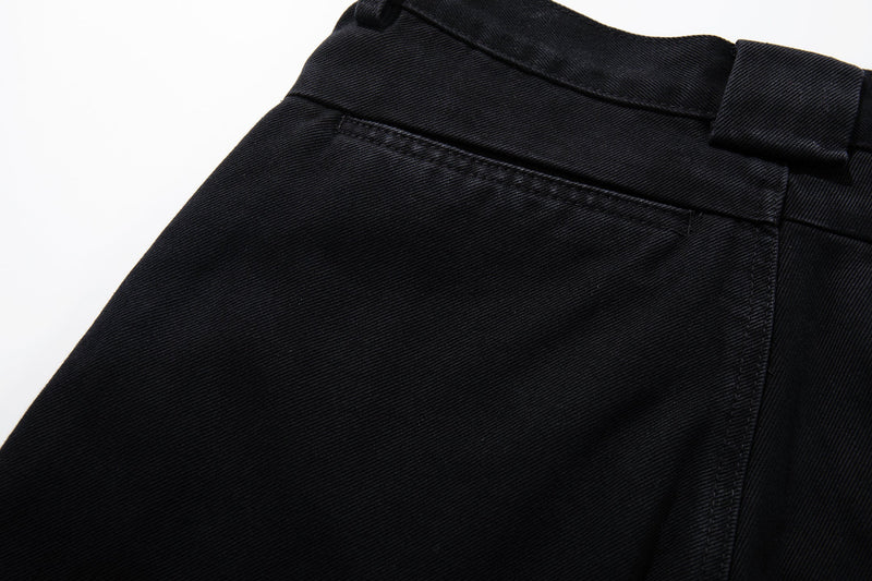 Close-up of black jeans back pocket area with top stitch detailing and smooth denim