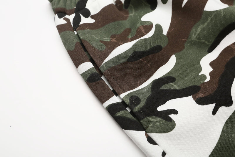 Close-up of camouflage fabric showing brown, green, black, and white pattern