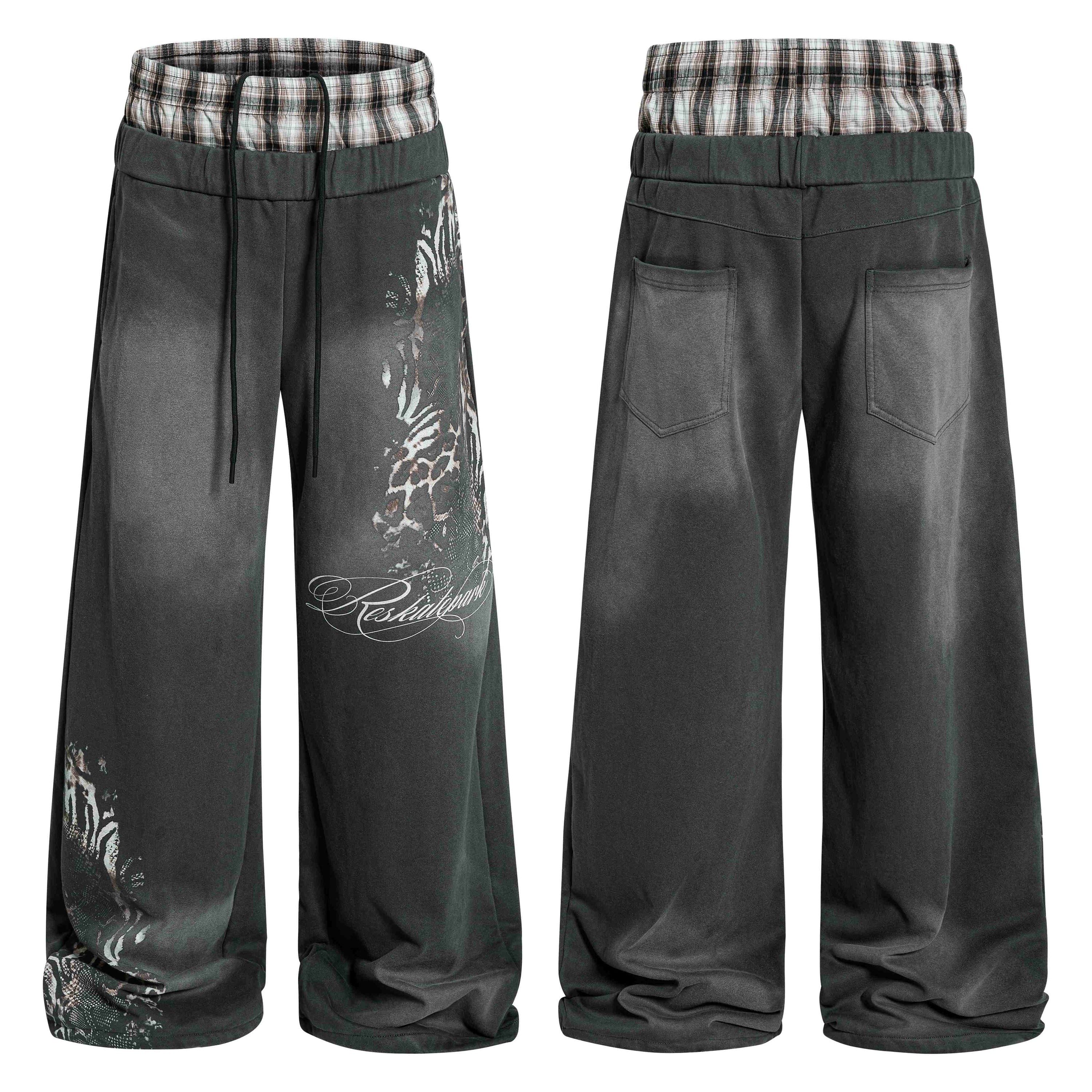 Front and back view of dark grey washed wide-leg sweatpants with faded leopard graphic print and plaid layered waistband