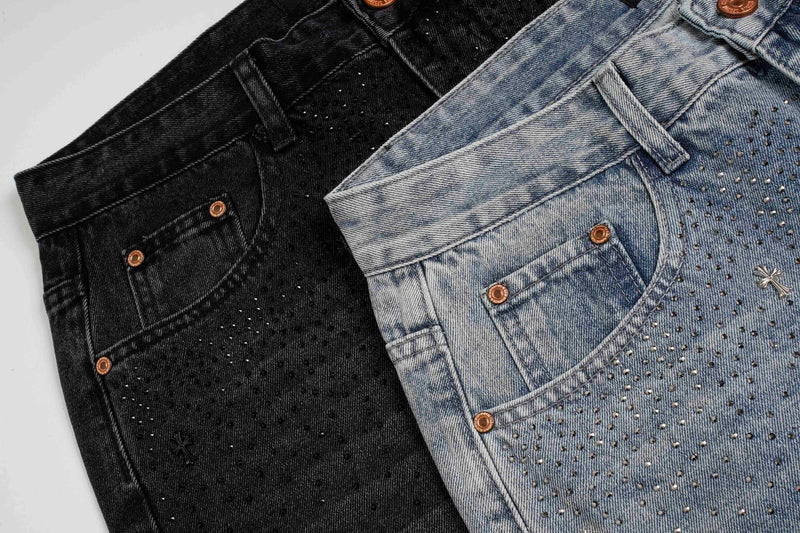 Close-up of black and light wash jeans with rhinestones and copper buttons